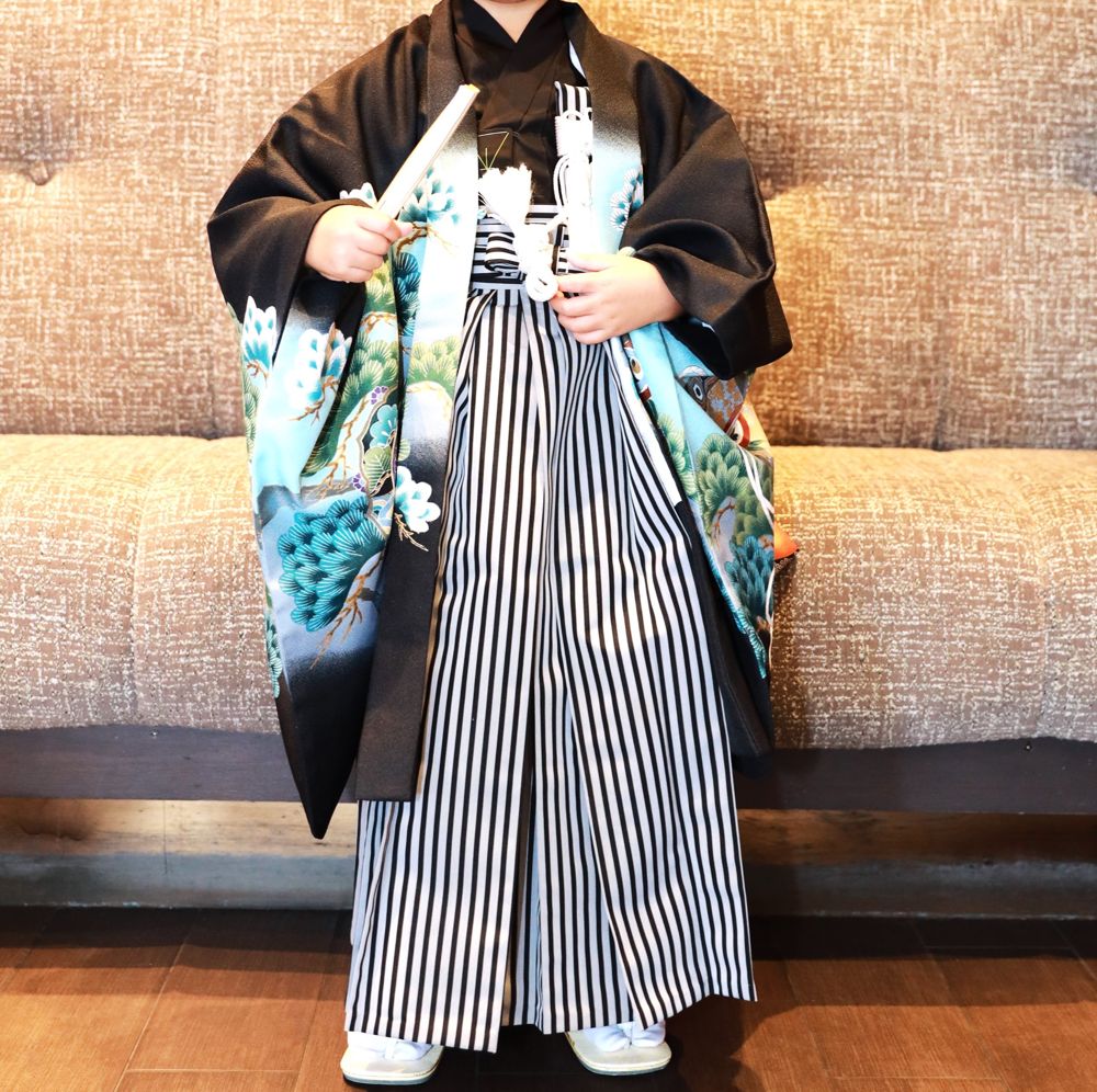 Black and aqua boy's haori with pine trees and striped hakama