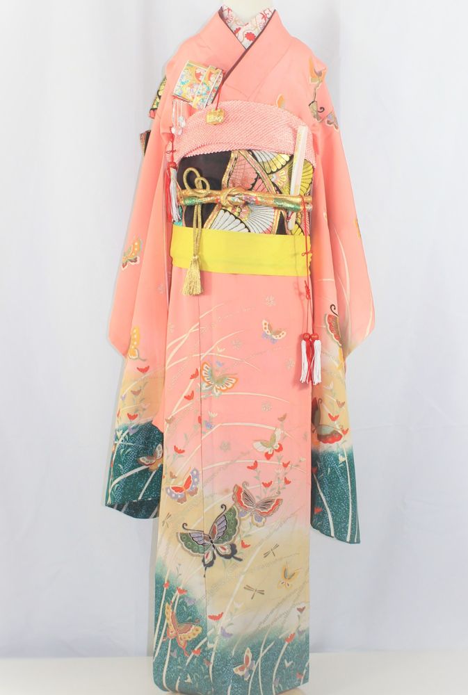 Coral children's kimono with butterflies and green meadow hem
